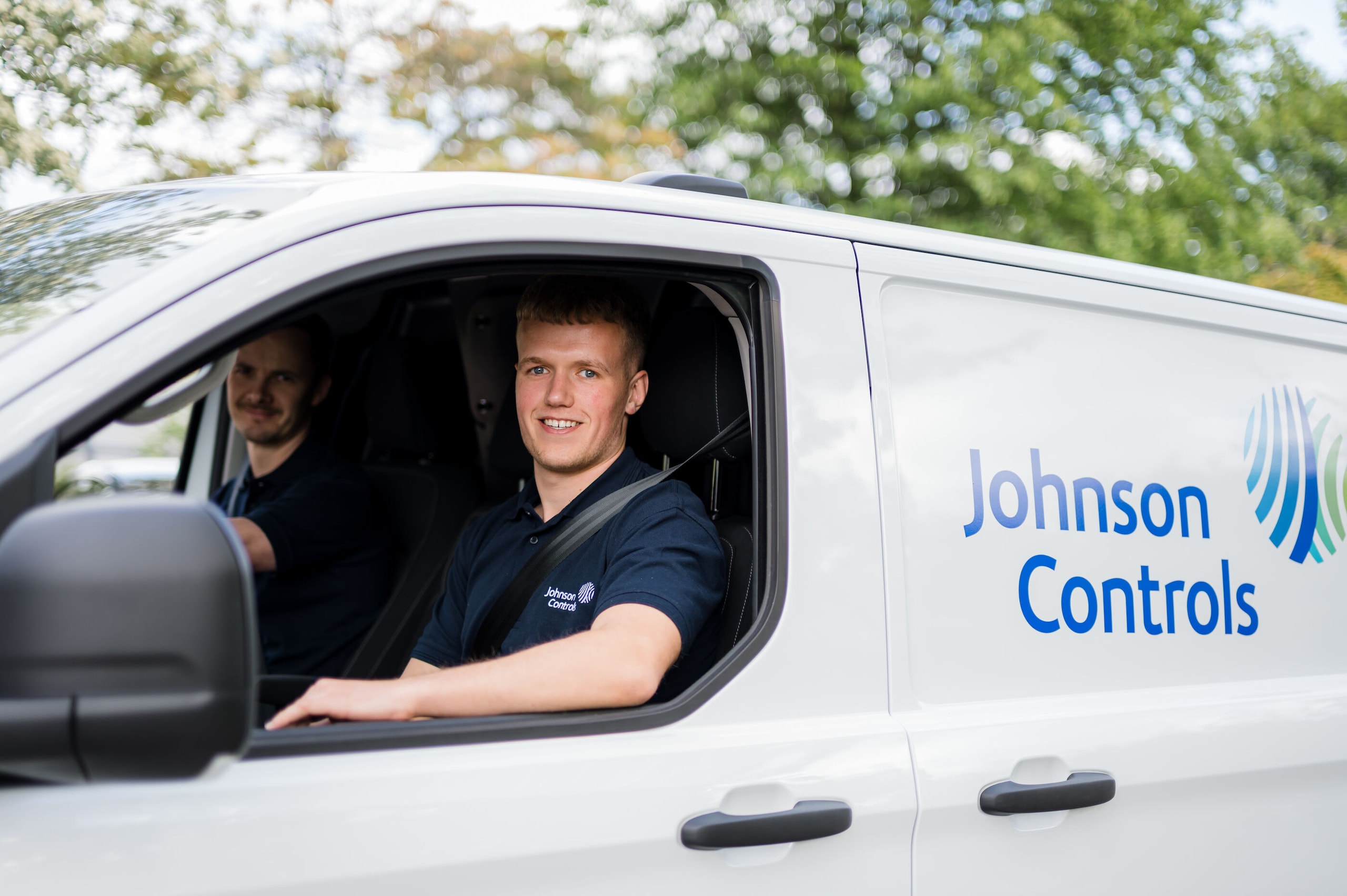 Johnson Controls employees in a car