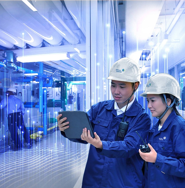Two Johnson Controls technicians using a tablet, overlaid with a graphic of transmission nodes