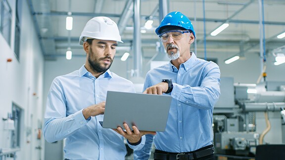 Two engineers looking at tab