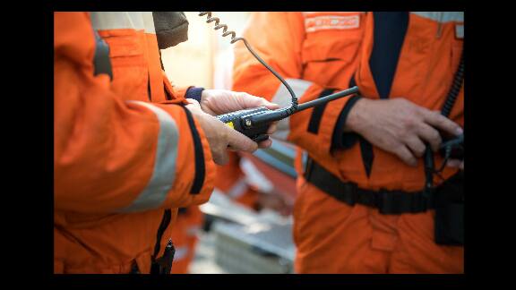 Two technicians holding monitoring devices