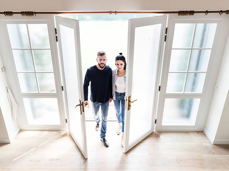 A couple entering their home