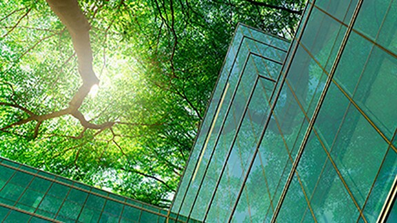 Top view of the glass building surrounded with trees