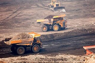 View of three dumptrucks at work in the mine