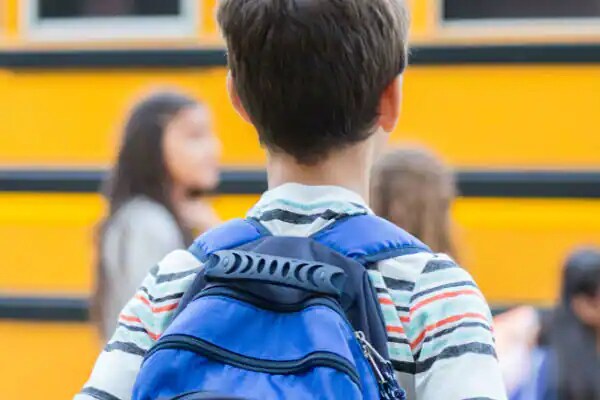Rear view of a boy with a backpack
