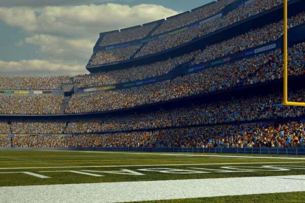Crowded stands across a football field in a stadium