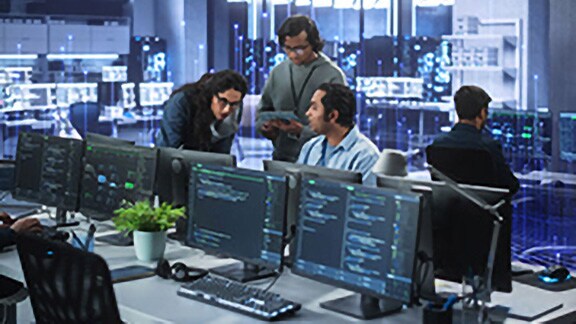 Employees discussing work in a control room, overlaid with a graphic of transmission nodes in the backgroound