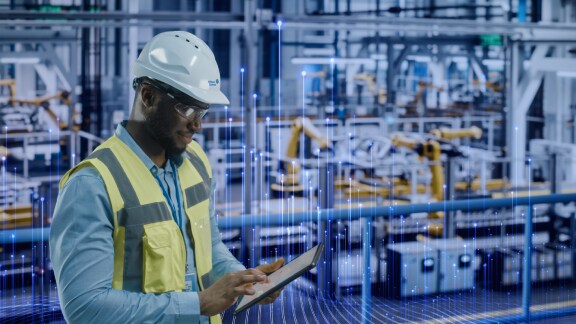 Johnson Controls technician using a tablet with HVAC equipments in the background