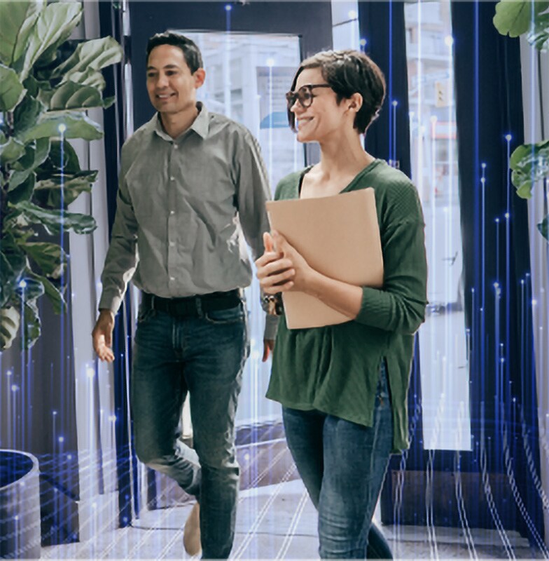 A man and a woman walking in a lobby