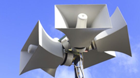 five megaphones attached to a pole