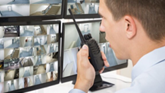 security officer speaking handheld transreceiver