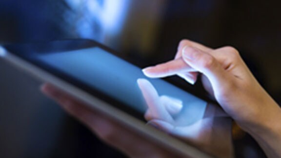 persons hand operating tablet closeup