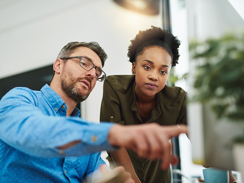 Two people looking at a monitor