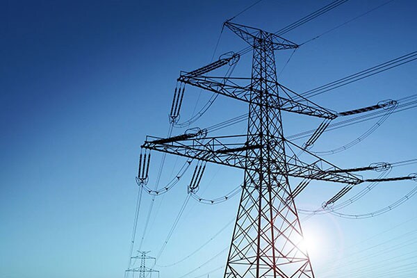 An electricity tower against the sky during the day