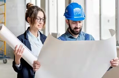 Two people at a construction site reading a chart