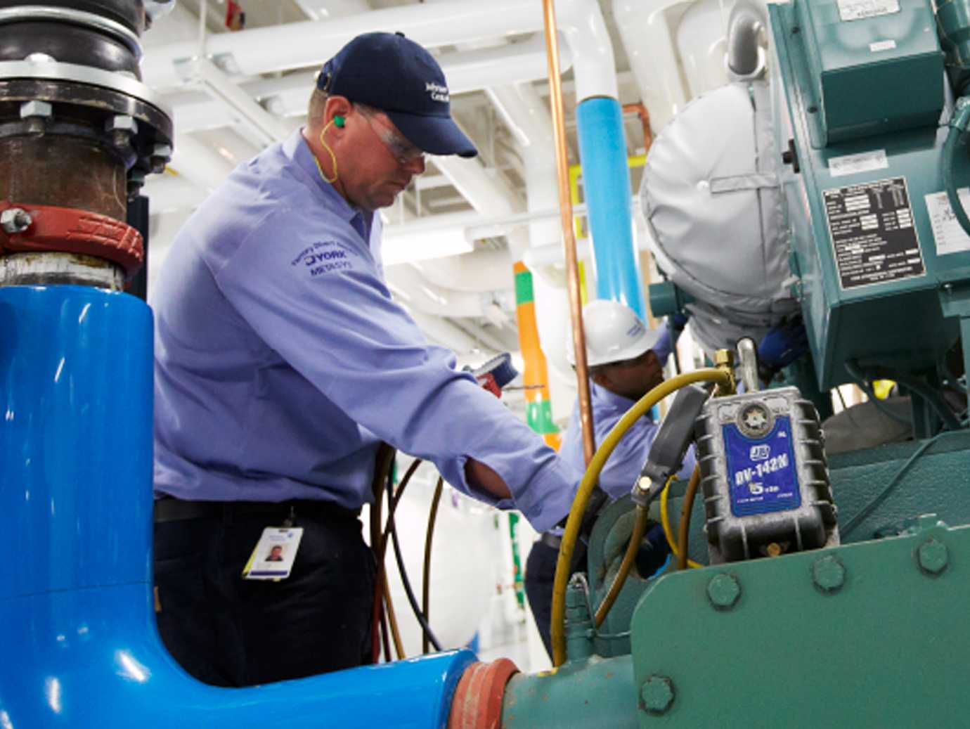An HVAC engineer inspecting equipment in an industrial facility