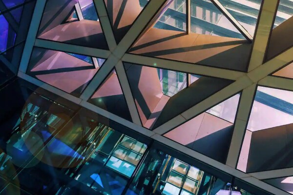 Looking up at the skylight of a modern glass office building