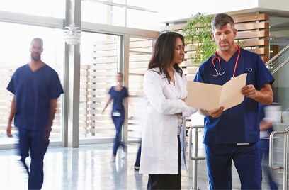 Medical practitioners conversing with motion in the background
