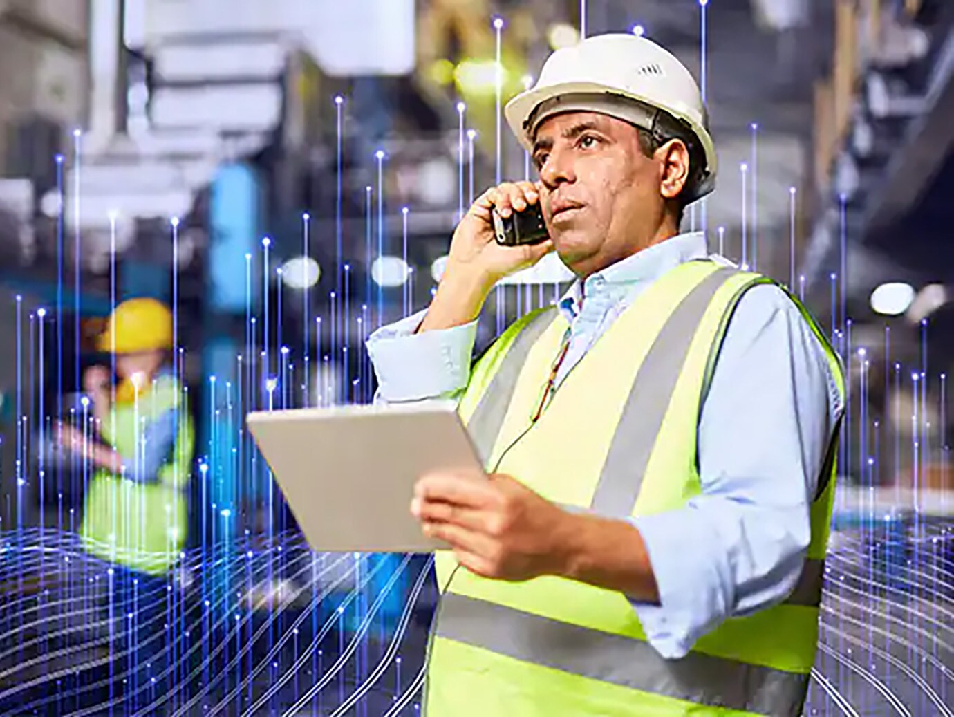 Man in safety gear using a tablet and a cellphone, overlaid with a graphic of transmission nodes