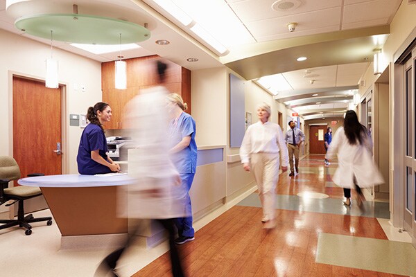 People walking in hospital corridor
