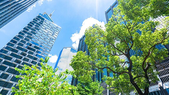 A  group of tall buildings with trees