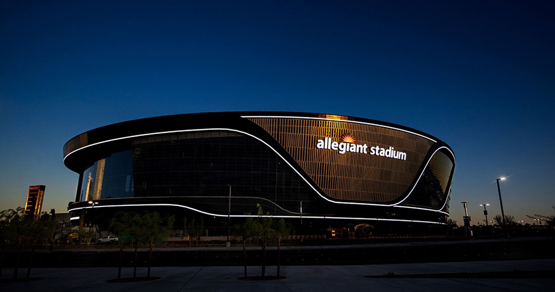 The Allegiant Stadium building lit up at night