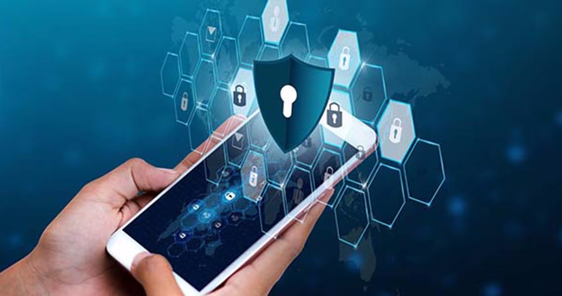 A mobile phone in someone's hand with graphics depicting security
