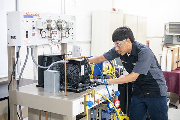 Students demonstrating what they have learned in programs benefiting from Johnson Controls Community College Partnership Program.