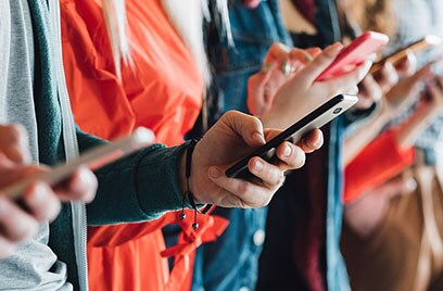 group of people checking mobiles