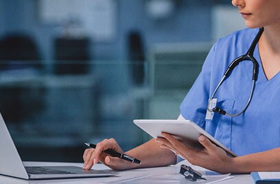 healthcare worker with pen laptop