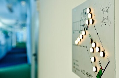 Floor map on a wall with circular lights switched on