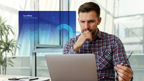 A man pondering while looking at a laptop, with a blue OpenBlue poster overlaid in the center