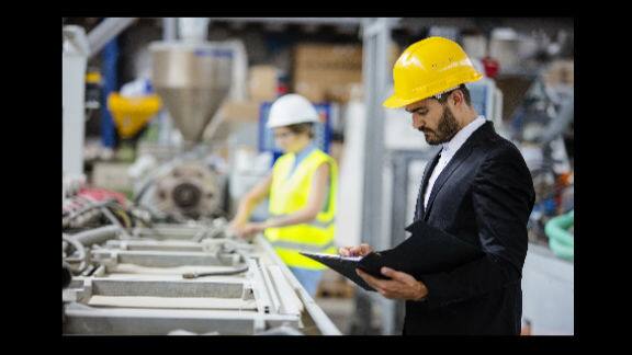 Management person with clip board supervising work